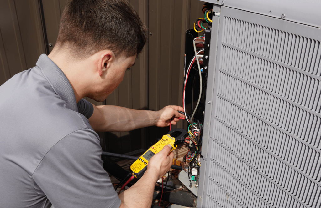 A Tyler Heating & Cooling employee testing a Carrier heat pump