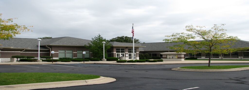 Parking lot and flag in front of the DeWitt Township headquarters